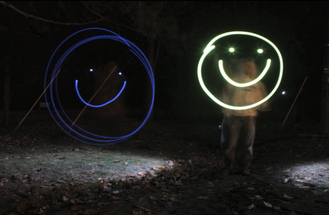 A light painting of smiley faces